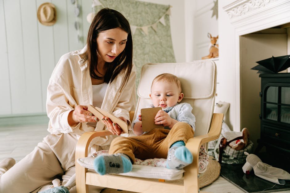 A mother and her baby enjoy bonding time while reading together indoors.